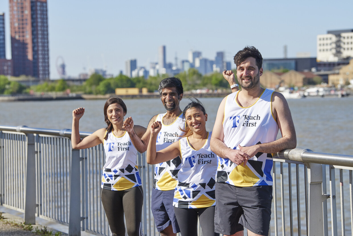 Four adults wearing Teach First running gear