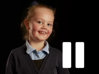 Young girl stands in front of pause shape