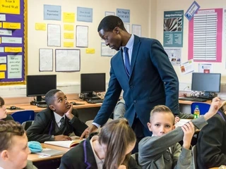 Image of teacher pointing at pupil's work