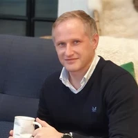 Michael Britland holding a cup of tea