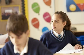 secondary pupils in class with worksheets