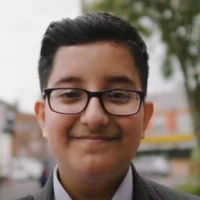 Rayyan, pupil wearing glasses smiling at camera