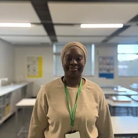 Richi, a Teach First trainee teacher, smiling in a classroom.