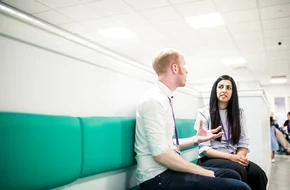 Image of two teachers sat down talking to each other