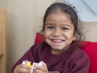 Young girl sits with a book