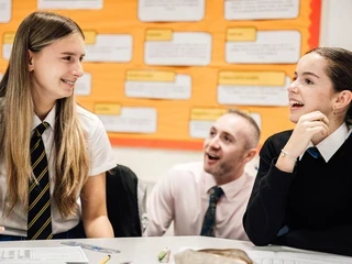 Teacher with two secondary school students